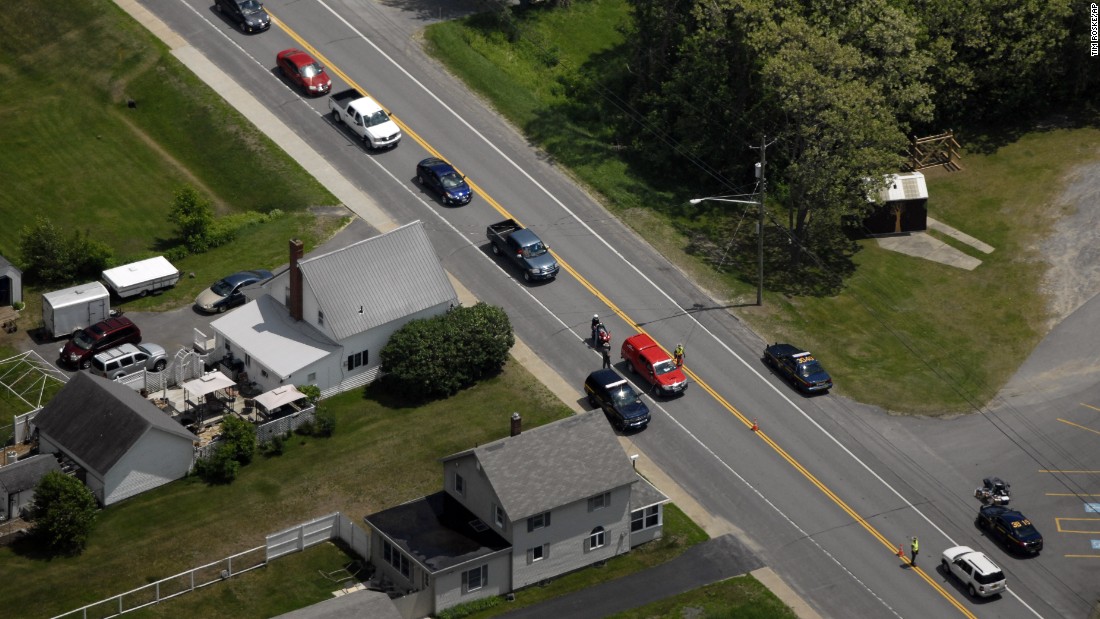 Authorities block a road in Cadyville during the manhunt on June 11.