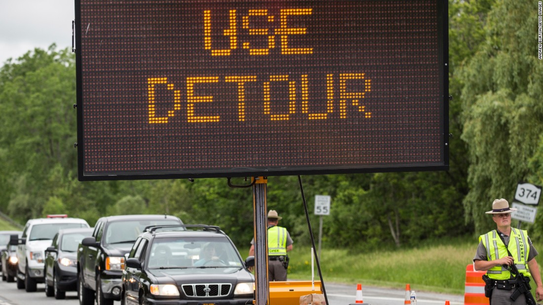 New York State Troopers stop civilian cars at a checkpoint outside Dannemora on Monday, June 15.