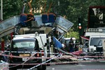 The wreckage of a double-decker bus with its top blown off and damaged cars scattered on the road at Tavistock Square in central London in this July 7, 2005 file photo.