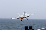 An F/A-18C Hornet assigned to the Thunderbolts of Marine Strike Fighter Squadron 251 takes off from the flight deck of the aircraft carrier USS Theodore Roosevelt conducting strike operations in Iraq and Syria as directed, 2 July, 2015.