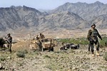 File - Afghan Army soldiers patrol near the village of Kusheh, Khost Province, Afghanistan, March 24, 2010.