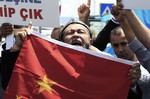 File - Uighurs living in Turkey and Turkish supporters, chant slogans as they hold a Chinese flag before burning it during a protest near China's consulate in Istanbul, Sunday, July 5, 2015, against what they call oppression by the Chinese government to Muslim Uighurs in far-western Xinjiang province.