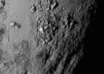 New close-up images of a region near Pluto’s equator reveal a giant surprise: a range of youthful mountains rising as high as 11,000 feet (3,500 meters) above the surface of the icy body, 15 July, 2015.