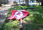 Bodies lie on the ground with one being covered with a Federation of the Socialist Youth Associations flag, after an explosion, in the southeastern Turkish city of Suruc near the Syrian border, Turkey, Monday, July 20, 2015.