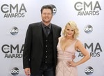 FILE - In this Nov. 5, 2014 file photo, Blake Shelton, left, and Miranda Lambert arrive at the 48th annual CMA Awards in Nashville, Tenn.