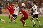 Bayern's Robert Lewandowski, left, watches as his shot on goal finds the net past, from 2nd left, Valencia's Shkrodan Mustafi, Bayern's Philipp Lahm, 2nd right, and Valencia's Lucas Orban during the second half of their friendly soccer match against Valencia in Beijing, Saturday, July 18, 2015.