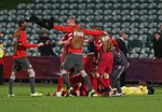 Serbian players celebrate after defeating Mali in extra time during their U20 soccer World Cup semifinal game in Auckland, New Zealand, Wednesday, June 17, 2015.