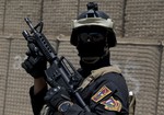 A member of the Iraqi Counter Terrorism Service forces participate in a training exercise as U.S. Defense Secretary Ash Carter observes at the Iraqi Counter Terrorism Service Academy on the Baghdad Airport Complex in Baghdad, Iraq, Thursday, July 23, 2015.