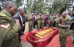 File - Members of the Kenya Police department's elite Recce Company and relatives pay their respects at the funeral of Corporal Benard Kipkemoi Tonui, who died in last week's attack on Garissa University College by al-Shabab militants, in the village of Cheleget, Kenya Saturday, April 11, 2015.