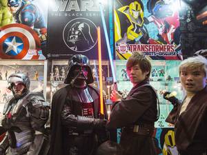 24 July 2015: Participants wearing costumes depicting their favourite characters, including Star Wars villain Darth Vader (C), pose at the 17th Ani-Com and Games exhibition in Hong Kong. The five-day festival of games, comics, animation and cosplay runs until 28 July