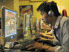 A chinese man plays online games at an internet cafe in Beijing