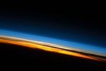 Limb view, of the Earth’s atmosphere. Colours roughly denote the layers of the atmosphere. The atmosphere of Earth is a layer of gases surrounding the planet Earth that is retained by Earth's gravity.