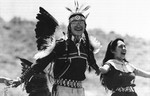 Derrick Davis, left, of Window Rock, Ariz., of the Hopi Navajo Choctaw tribe wore his native dance costume as he participated in Hands Actross America on Sunday, May 25, 1986 on Interstate 40 east of Gallup, New Mexico.