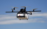 A DPD Geopost prototype drone files carrying a parcel flies during a test flight in Pourrieres, southern France, June 23, 2015.