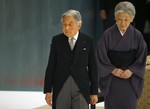 Japan's Emperor Akihito, accompanied by Empress Michiko, leaves after delivering his remarks during a memorial service at Nippon Budokan martial arts hall in Tokyo, Saturday, Aug. 15, 2015.