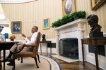 File - President Barack Obama holds a meeting in the Oval Office, Aug. 28, 2014.