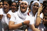 Yazidi Kurdish women chant slogans during a protest against the Islamic State group's invasion on Sinjar city one year ago, in Dohuk, northern Iraq, Monday, Aug. 3, 2015. Thousands of Yazidi Kurdish women and girls have been sold into sexual slavery and forced to marry Islamic State militants.