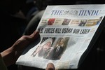 Kashmiri people read newspapers with cover stories of Osama bin Laden's death, in Srinagar, May 3, 2011.