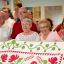 ADVANCE FOR THE WEEKEND OF JULY 18-19 AND THEREAFTER - In a July 10, 2015 photo, Alice Rotter, second from right, and her cousin Norma Jean Stevens of Rapid City, S.D., third from right, pose with their familys' cherry quilt with family members after donating their family's quilt to the International Quilt Study Center and Museum in Lincoln, Neb. The quilt, made in 1860, was passed down through the family and occasionally squabbled over. (Matt Ryerson/Lincoln Journal Star via AP)