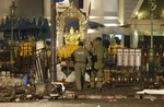 Explosive Ordnance Disposal officers enter the Erawan Shrine after an explosion in Bangkok, Monday, Aug. 17, 2015.