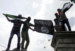 Protesters hold up a flag of the Islamic State of Iraq and the Levant (ISIL),shouts slogans during a protest against Israeli military operations in Gaza.