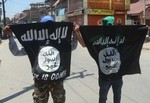 Kashmiri protestors hold up  flags of the Islamic state of iraq and the levant (ISIL) during protest in old city Srinagar,Saturday India 27, June 2015. Normal life in Srinagar got affected following a strike call given by separtists and Religious organizations against the alleged desecration of Jamia Masjid in Srinagar.