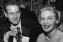 1958:  American actor Joanne Woodward holds her Oscar statuette while sitting next to husband, American actor Paul Newman, during the Governor's Ball, an Academy Awards party held at The Beverly Hilton Hotel, Beverly Hills, California. Woodward won the Best Actress Oscar for director Nunnally Johnson's, 'The Three Faces of Eve.'  (Photo by Darlene Hammond/Hulton Archive/Getty Images)