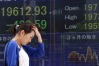 A pedestrian walks past an electronic board displaying the the Nikkei 225 Stock Average figure, left, outside a securities firm in Tokyo, Japan, on Friday, Aug. 21, 2015.Japanese stocks plunged, with the Topix index heading for its worst weekly loss in 10 months, following a $500 billion rout in U.S. shares as concern intensifies that global economic growth is slowing. Photographer: Tomhoiro Ohsumi/Bloomberg