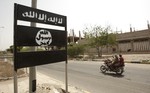 File - In this Friday, June 15, 2012 file photo, an al-Qaida logo is seen on a street sign in the town of Jaar in southern Abyan province, Yemen. Arabic on the logo reads, "There is no god but God," and "Muhammad is the messenger of God."