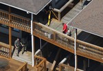 Investigators look at the body of WDBJ-TV cameraman Adam Ward after he and reporter Alison Parker were fatally shot during an on-air interview, Wednesday, Aug. 26, 2015, in Moneta, Va.