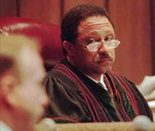 Tennessee state Criminal Court Judge Joe Brown listens to testimony by forensics scientist Robert Hathaway during a special hearing in Memphis on Thursday, Feb. 20, 1997, by lawyers seeking a trial for James Earl Ray. Ray, who pleaded guilty to King's 1968 slaying, reversed himself almost immediately and has been requesting a trial ever since. He asked for the rifle tests in an attempt to take back his guilty plea and go to trial - a move supported by the widow and son of the slain civil rights leader.(AP Photo/John L. Focht)