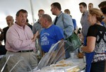 Republican presidential candidate, New Jersey Gov. Chris Christie, left, talks with Rallitsa Kostakis, right, in Manchester, N.H., Saturday, Aug. 29, 2015.