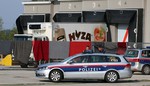 Blankets cover the view on a truck that is investigated at a veterinary border station at the Austrian/Hungarian border in Nickelsdorf, Austria, Friday, Aug 28, 2015. The truck was found parked on a main Austrian highway on Thursday with 71 migrants suffocated to death.