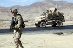 File - U.S. Army Pfc. Samuel Ford, 1st Platoon, Bravo Company, 2nd Battalion, 4th Infantry Regiment, 4th Brigade Combat Team, 10th Mountain Division walks next to his vehicle in order to clear and document culverts along a highway in the Wardak province, Afghanistan, Dec. 21, 2010.