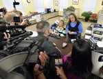 Rowan County Clerk Kim Davis, right, talks with David Moore following her office's refusal to issue marriage licenses at the Rowan County Courthouse in Morehead, Ky., Tuesday, Sept. 1, 2015.