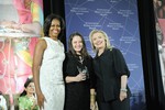 U.S. Secretary of State Hillary Rodham Clinton, right; and First Lady Michelle Obama, left; pose for a photo with 2012 International Women of Courage (IWOC) Award Winner Jineth Bedoya Lima of Colombia, at the U.S. Department of State in Washington, D.C., on March 8, 2012