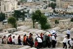 In this Sept. 1, 2005 file photo, Israeli men carry a coffin wrapped in an Israeli flag and a prayer shawl, as women follow, during a reburial ceremony for fifteen Jewish settlers at the Mt. of Olives cemetery in Jerusalem.