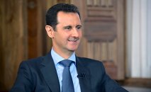 Syria's President Bashar al-Assad answers questions during an interview with al-Manar's journalist Amro Nassef, in Damascus, Syria, in this handout photograph released by Syria's national news agency SANA on August 25, 2015