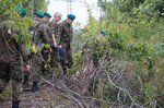 Polish military officials inspect the site where, according to two men, a World War II armored train is hidden in the ground, in Walbrzych, Poland, on Friday, Sept. 4, 2015.