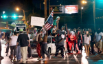 Protesters march along on West Florissant Avenue in Ferguson on Monday, Aug. 10, 2015. Photo by David Carson