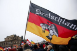 Members of the movement of Patriotic Europeans Against the Islamisation of the West (PEGIDA) hold flags and banners during a PEGIDA demonstration march in Dresden, January 25, 2015.Hannibal Hanschke/Reuters