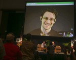 File - National Security Agency leaker Edward Snowden appears on a live video feed broadcast from Moscow at an event sponsored by the ACLU Hawaii in Honolulu on Saturday, Feb. 14, 2015.