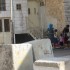 Settler women with their children blocking the stairs to the Abu Rajab house