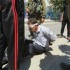 Palestinian man sitting on the ground in pain