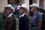 Guatemalans wait in line during general elections at a polling station in San Juan Sacatepequez, Guatemala, Sunday Sept. 6, 2015.