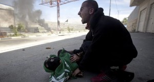 Medic pressing against Mohammad Odeh’s chest after he was shot with live ammunition. May 15th, 2014 - photo by AP