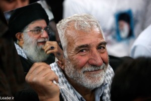 An Iranian man holding a photo of Supreme Leader Ali Khamenei. (Iranian government photo)