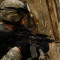 File: An armed U.S. soldier stands guard over Iraqi residents as his platoon searches their house on January 28, 2008. (Flickr / U.S. Air Force / Staff Sgt. Jason T. Bailey)