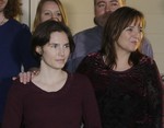 File - Amanda Knox, left, walks with her mother, Edda Mellas, right, to talk to the media outside Mellas' home, Friday, March 27, 2015, in Seattle.