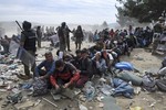 Refugees and migrants wait to cross the border from the northern Greek village of Idomeni to southern Macedonia, Monday, Sept. 7, 2015.